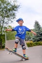 Happy boy practicing balancing on a skateboard Royalty Free Stock Photo