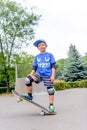 Happy boy practicing balancing on a skateboard Royalty Free Stock Photo