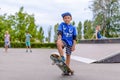 Happy boy practicing balancing on a skateboard Royalty Free Stock Photo