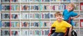 Composite image of happy boy pushing friend on wheelchair Royalty Free Stock Photo