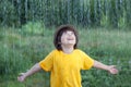 Happy boy in rain summer