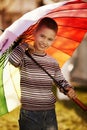 Happy boy with a rainbow umbrella in park Royalty Free Stock Photo