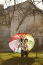 Happy boy with a rainbow umbrella in park Royalty Free Stock Photo