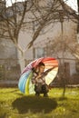 Happy boy with a rainbow umbrella in park Royalty Free Stock Photo