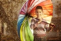 Happy boy with a rainbow umbrella in park Royalty Free Stock Photo