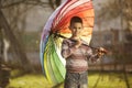 Happy boy with a rainbow umbrella in park Royalty Free Stock Photo