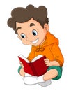 The happy boy is reading the story book in the library Royalty Free Stock Photo