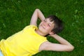 Happy boy resting on grass Royalty Free Stock Photo