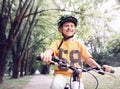 Happy boy ride a bicycle in city park