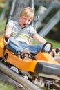 Happy boy riding at bobsled coaster rail trac Royalty Free Stock Photo