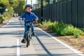 Happy boy riding his bicycle on bike lane Royalty Free Stock Photo