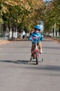 Happy boy riding his little bicycle