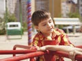 Happy boy riding on a spinning swing Royalty Free Stock Photo