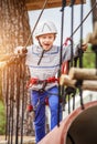 Happy boy on rope track in adrenalin park