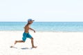 Happy boy is running along the sea shore. Royalty Free Stock Photo