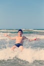 Happy boy running and jumping at shallow sea water Royalty Free Stock Photo