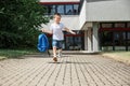 Happy boy running from school at the end of the school day with a backpack in hand. The beginning of the vacation Royalty Free Stock Photo