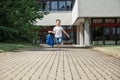 Happy boy running from school at the end of the school day with a backpack in hand. The beginning of the vacation. End of lessons Royalty Free Stock Photo