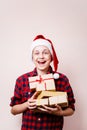 Happy boy in Santa hat with stack of gift boxes Royalty Free Stock Photo