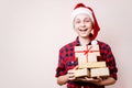 Happy boy in Santa hat with stack of gift boxes Royalty Free Stock Photo