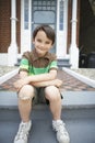 Happy Boy Sitting On Front Steps Of House Royalty Free Stock Photo
