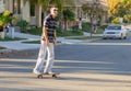 Happy boy skates on the street at dusk Royalty Free Stock Photo