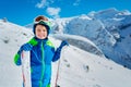 Happy boy with ski standing over mountains Royalty Free Stock Photo