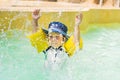 Happy boy splashing water around him in pool Royalty Free Stock Photo