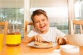 Happy boy spreading chocolate on his toast Royalty Free Stock Photo