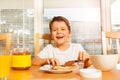 Happy boy spreading chocolate with knife on toast Royalty Free Stock Photo