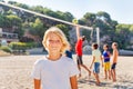 Happy boy standing on beach volleyball court Royalty Free Stock Photo