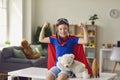 Happy boy in superhero costume showing strength at home. Creative kid dressed as superman playing indoors Royalty Free Stock Photo