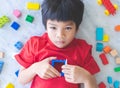 Boy surrounded by colorful toy blocks top view open windows to the heart