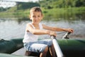 Happy boy swimming in fishing boat Royalty Free Stock Photo