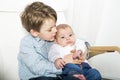 Happy boy talking to his newborn baby sister Royalty Free Stock Photo