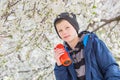 Happy boy teenager with portable wireless speaker listening to music