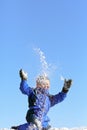 Happy boy throwing snow