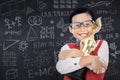 Happy boy with trophy in class Royalty Free Stock Photo