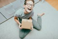 A happy boy unboxing unpacking a parcell, delivery, online shopping purchase concept Royalty Free Stock Photo