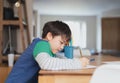 Happy boy using pencil drawing or sketching on paper,Portrait  kid siting on table doing homework in living room,Child enjoy art Royalty Free Stock Photo