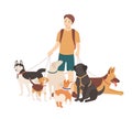 Happy boy walking his purebred dogs on leash. Young smiling guy standing with domestic animals. Cute funny pet owner