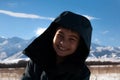 Happy boy walking in sunny mountains children`s clothing for the mountains close smiling portrait