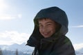 happy boy walking in sunny mountains children\'s clothing for the mountains close smiling portrait Royalty Free Stock Photo