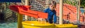 Happy boy on water slide in a swimming pool having fun during summer vacation in a beautiful tropical resort BANNER Royalty Free Stock Photo