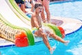 A happy boy on water slide in a swimming pool having fun during summer vacation in a beautiful aqua park. A boy Royalty Free Stock Photo