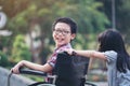 Happy boy in wheelchair with girl try drive a wheelchair of her Royalty Free Stock Photo