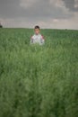 Happy boy young man on a green grain field Royalty Free Stock Photo