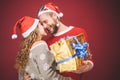 Happy boyfriend surprising his girlfriend giving her a christmas present - Young couple having fun celebrating xmas holidays Royalty Free Stock Photo