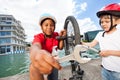 Happy boys fixing bike together outdoors in summer Royalty Free Stock Photo