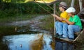 Happy boys go fishing on the river, Two children of the fisher with a fishing rod on the shore of lake Royalty Free Stock Photo